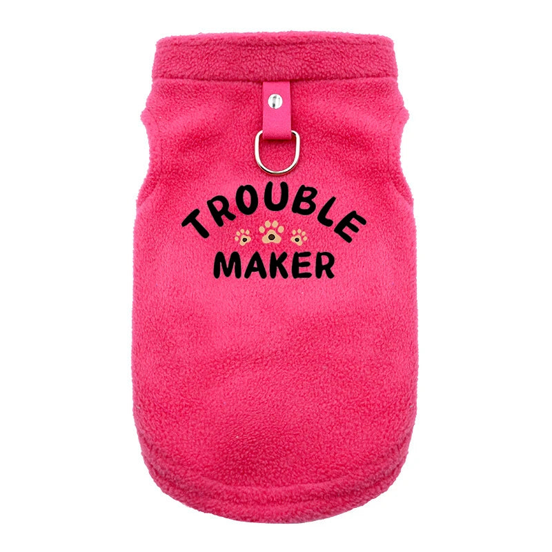 A bright pink, fuzzy pet jacket for dogs with a metal clasp.