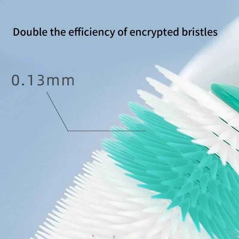 Close-up of a white silicone pet toothbrush with green bristles, showing the brush head and a measurement line.