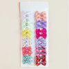 A collection of colorful pet hair clips for dogs and cats in various pastel shades like pink, purple, yellow, and green.