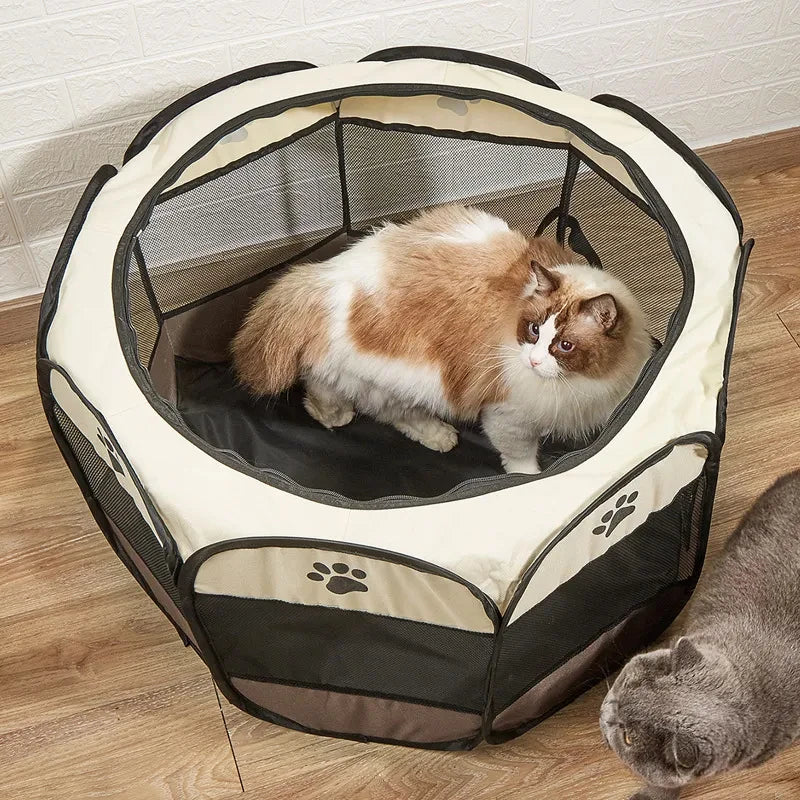 A fluffy orange and white cat is relaxing inside a beige and black folding octagonal pet cage.