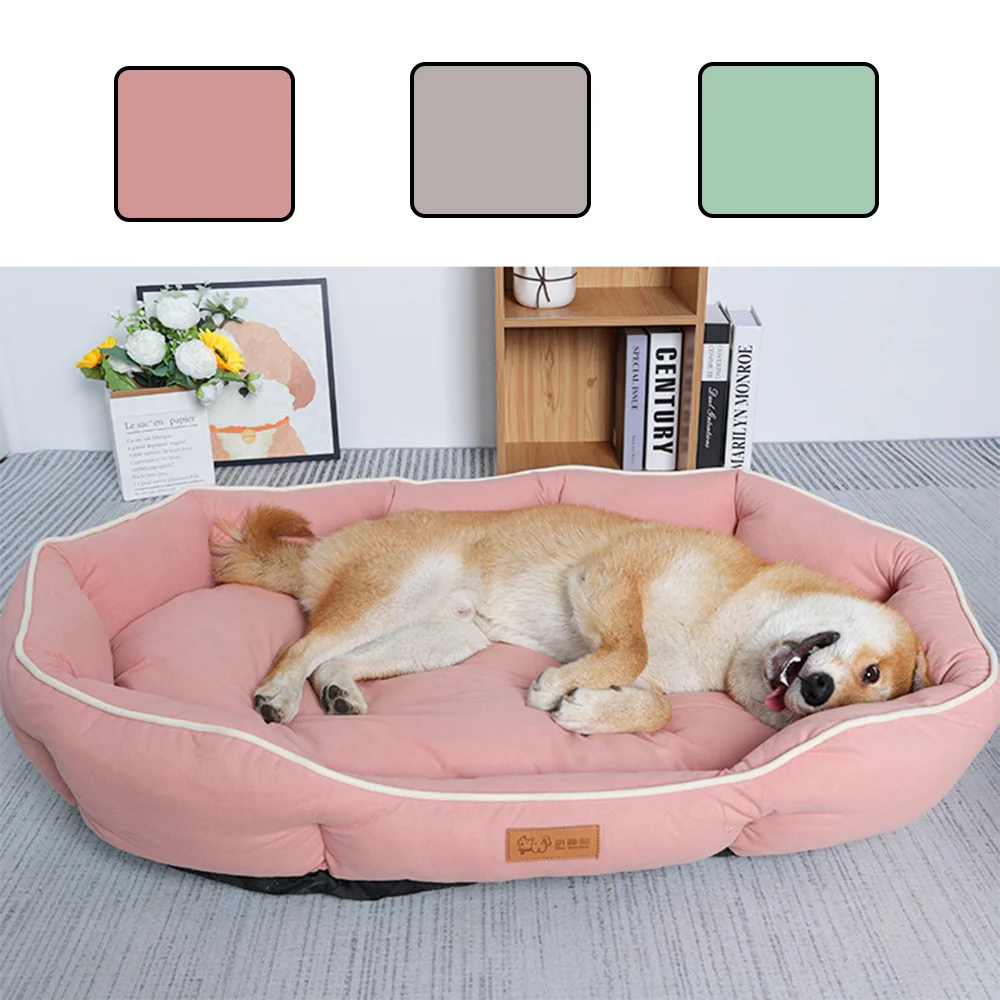 A light pink corduroy pet sofa bed for dogs and cats resting on a gray carpet.