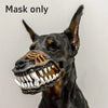 A black dog wearing a realistic, open-mouthed muzzle costume with visible teeth.