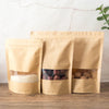 Three reusable kraft paper zipper bags filled with white grains, dried fruits, and nuts.