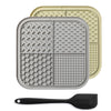 A gray silicone lick mat for pets is shown next to a black silicone spoon.