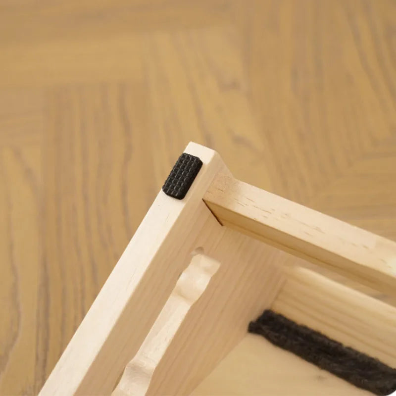 Close-up view of solid wood pet stairs with non-slip steps showing the wooden structure and dark felt grips.