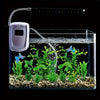 A clear glass aquarium containing vibrant green artificial water grass plants and a white air pump.