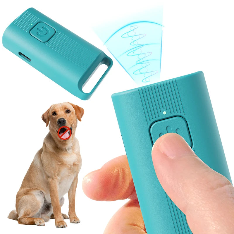 A hand holds a teal portable ultrasonic dog repeller device, with a dog visible in the background.