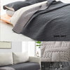 Dark grey reversible waterproof pet mat with a textured pattern shown in various contexts.