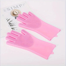 A pair of bright pink silicone pet grooming and cleaning gloves are displayed on a white background.