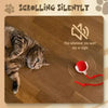 A cat is interacting with an automatic rolling interactive ball for cats.