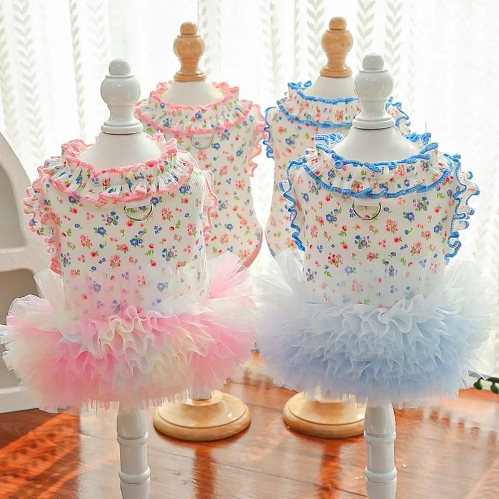A display of floral princess pet dresses for dogs and cats in various colors like pink and blue.