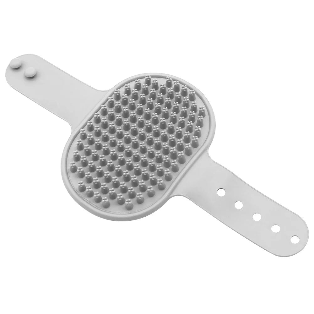 A white rubber pet grooming brush with an adjustable handle and a textured head.