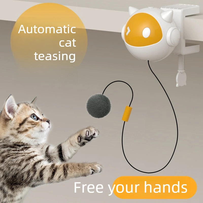 A small, round, orange cat toy is shown being played with by a tabby kitten.