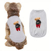 A gray printed vest for a dog is shown next to its fur, featuring a small teddy bear graphic.