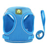 Blue adjustable mesh dog harness with a reflective strip and attached leash