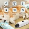 A fluffy orange dog is lying down next to a white electric dog nail grinder device.