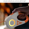 A hand is holding a white and orange double-sided RGB light ring device.