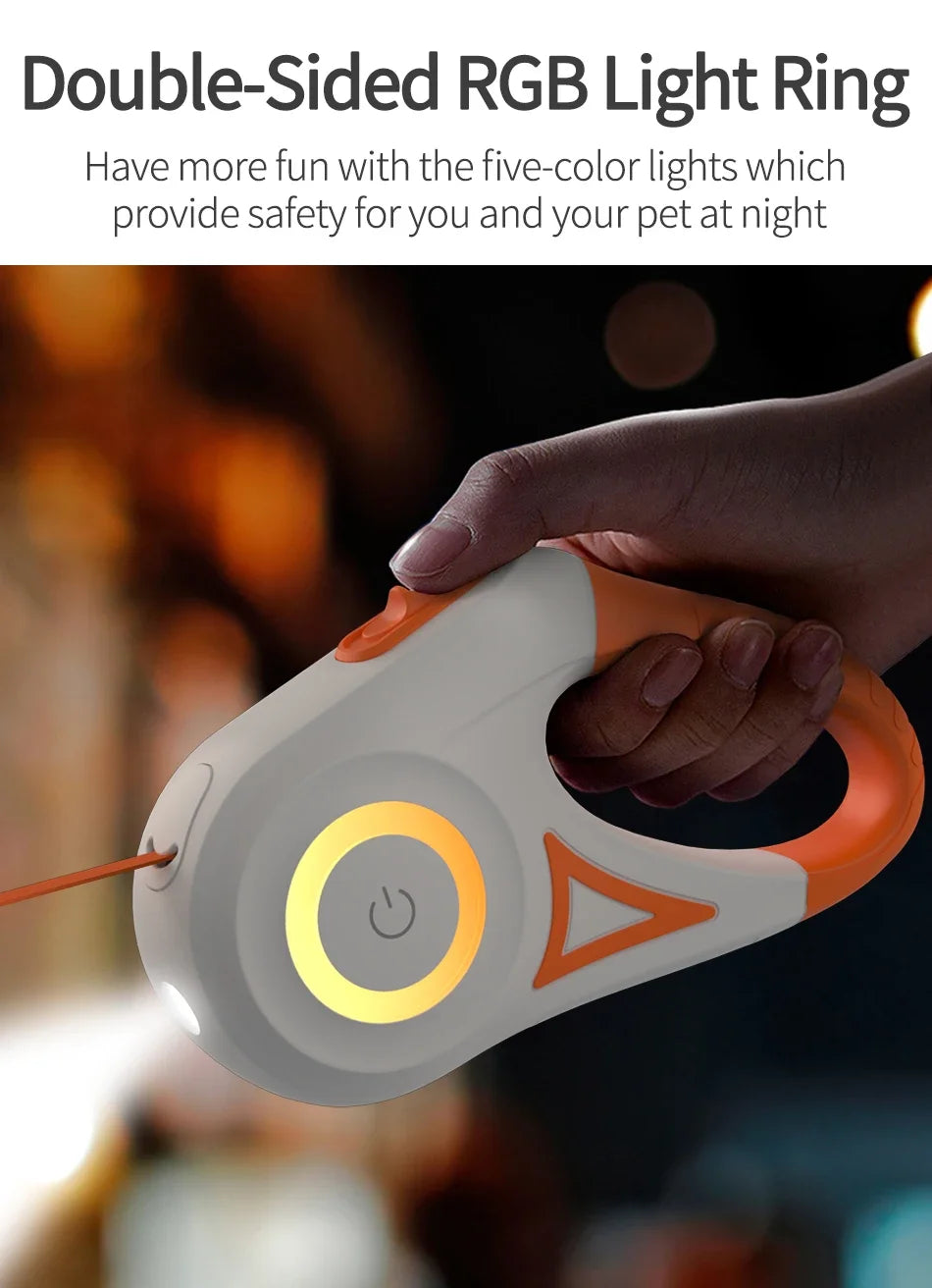 A hand is holding a white and orange double-sided RGB light ring device.