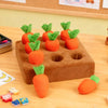 An interactive snuffle mat for pets shaped like carrots, featuring orange and green textures.