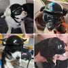 A black pet safety helmet and goggles set is shown on a dog's face.