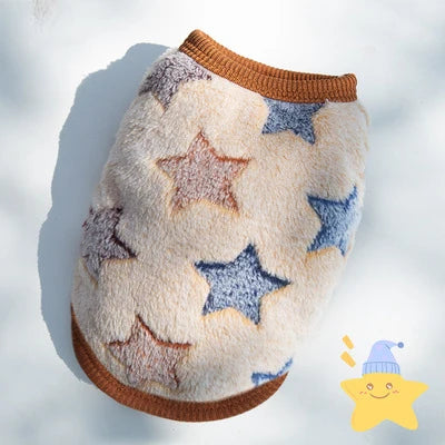 A fluffy, star-patterned fleece puffer vest for small pets, featuring beige and blue stars.