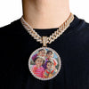 A gold-finished chain necklace with a round pendant featuring a photo of a family.