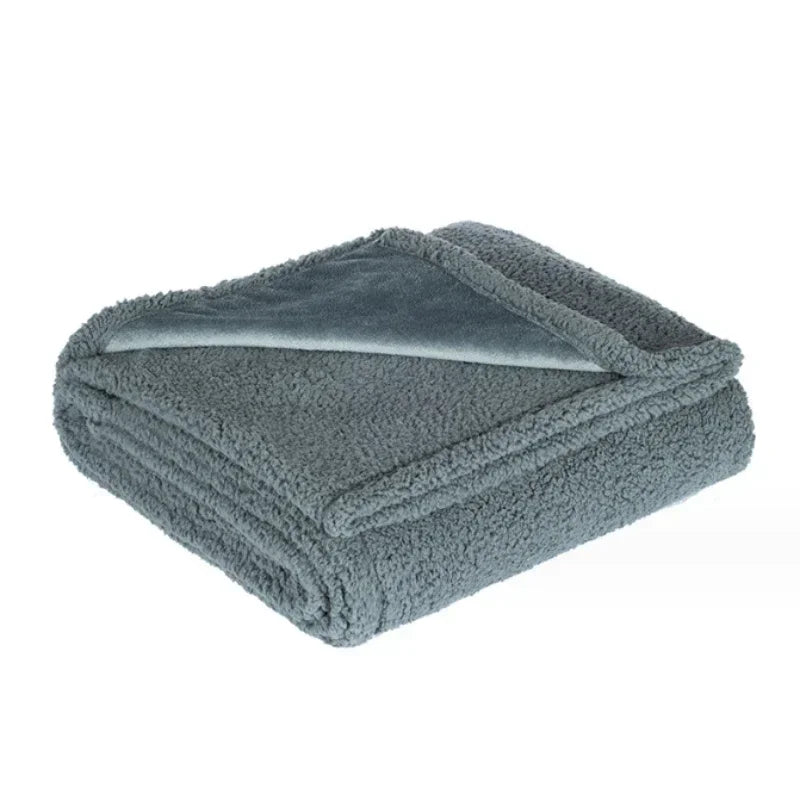 A gray microfiber blanket folded and displayed on a white background.