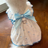 A white lightweight cotton dog dress with a heart print and light blue ruffle collar and bow