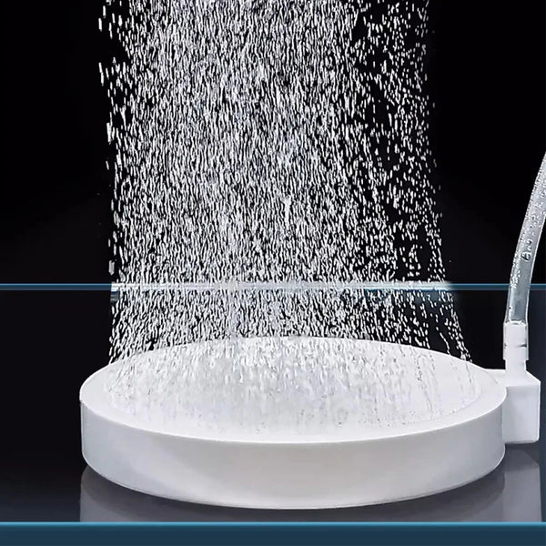 A white aquarium air stone disc diffuser is shown spraying fine bubbles into a clear container.