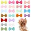 A collection of colorful pet hair clips for dogs and cats in various pink, purple, orange, and pastel shades.