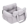 A light gray durable pet car seat with safety straps shown from the side.