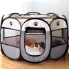 A portable foldable pet playpen with a mesh enclosure and black frame, featuring paw print designs.