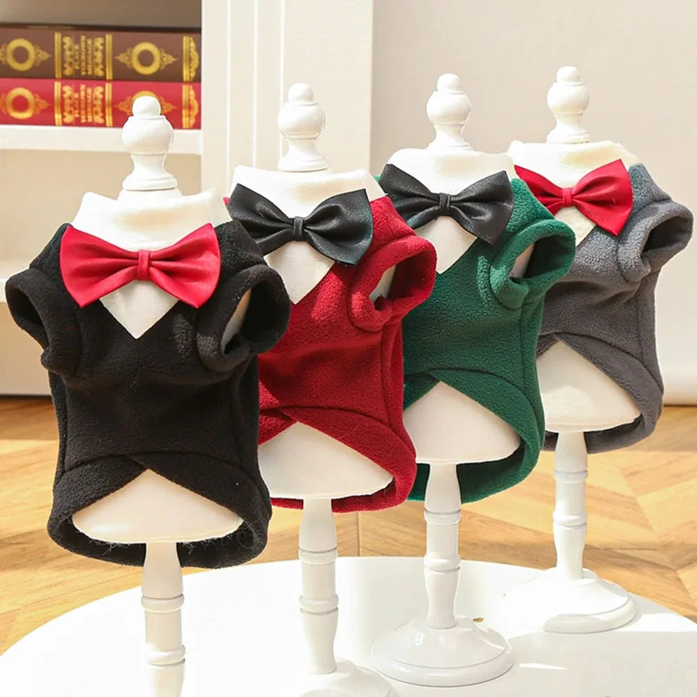 A display of a warm fleece dog tuxedo costume with a bow tie for large breeds in various colors like black, red, and green.