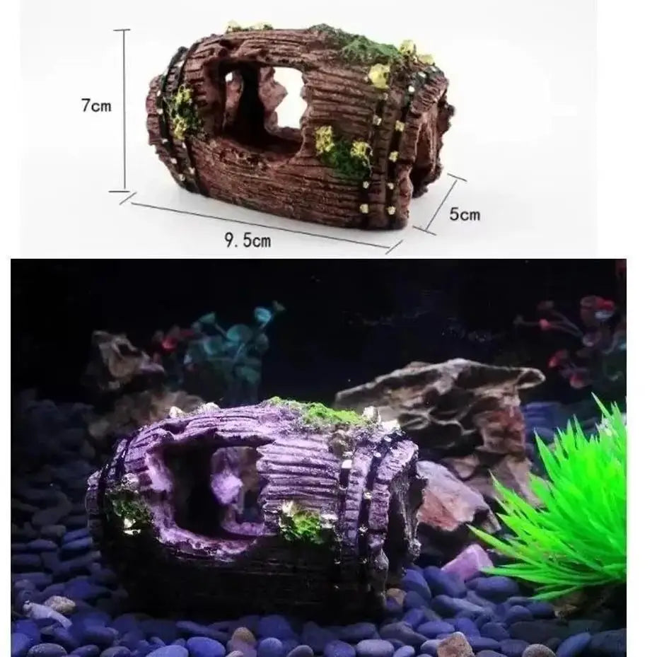 A resin broken barrel fish tank decoration covered in moss, displayed on a dark gravel substrate.