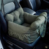 A green durable pet car seat with safety straps is shown installed in a dark car interior.