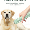 A hand is using a light green pet grooming brush on a golden Labrador dog for hair care.