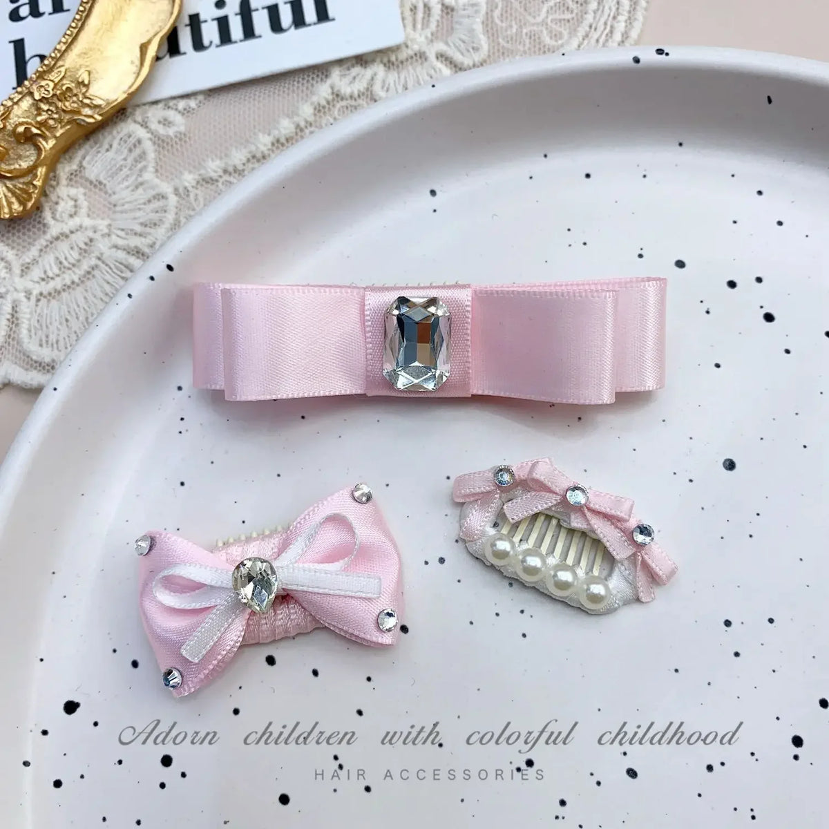 Pink bow hair accessory featuring a rhinestone and pearl accent for children's hair