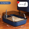 A blue semi-enclosed cat litter box with a scoop and splash guard is shown on a wooden floor.