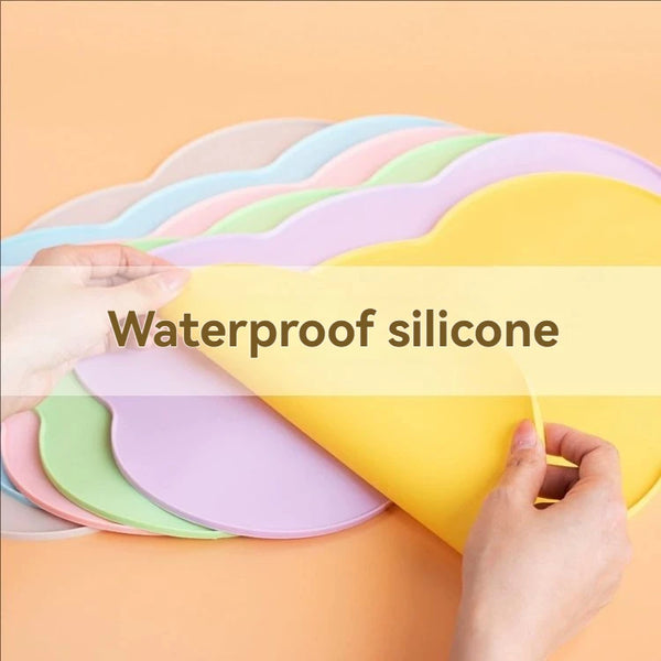 Hands are holding a stack of colorful waterproof silicone pet feeding mats for dogs and cats.