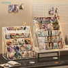 Clear acrylic display stand holding various business cards and brochures.