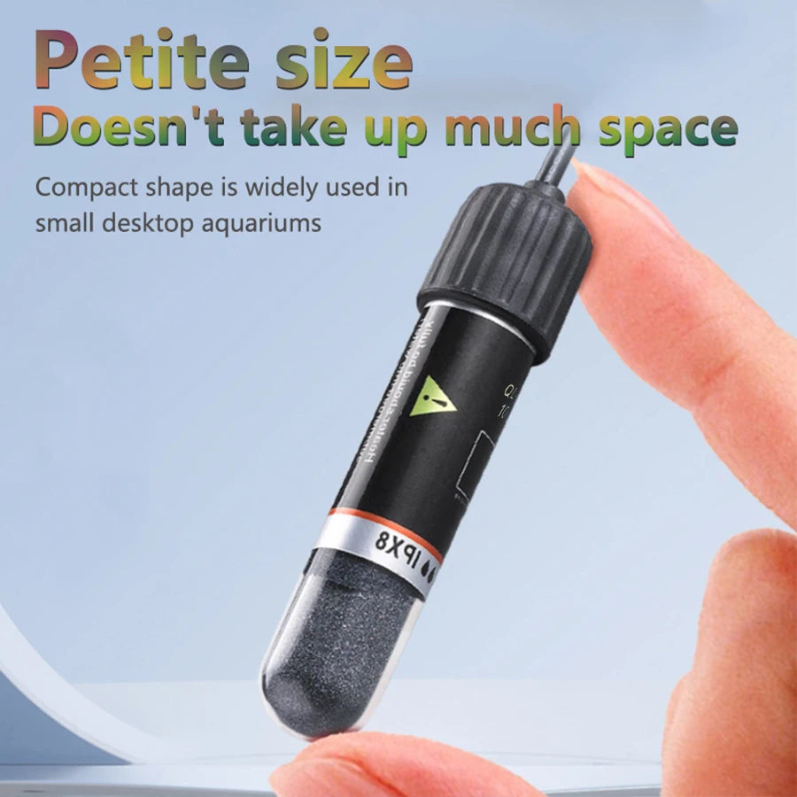 A close-up of a black USB mini aquarium heater with an aluminum tip being held by a hand.