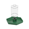 A clear glass automatic reptile water dispenser bowl sitting on a green plastic tray.