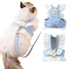 A light blue elegant princess cat harness and leash set with floral accents shown on a white cat.