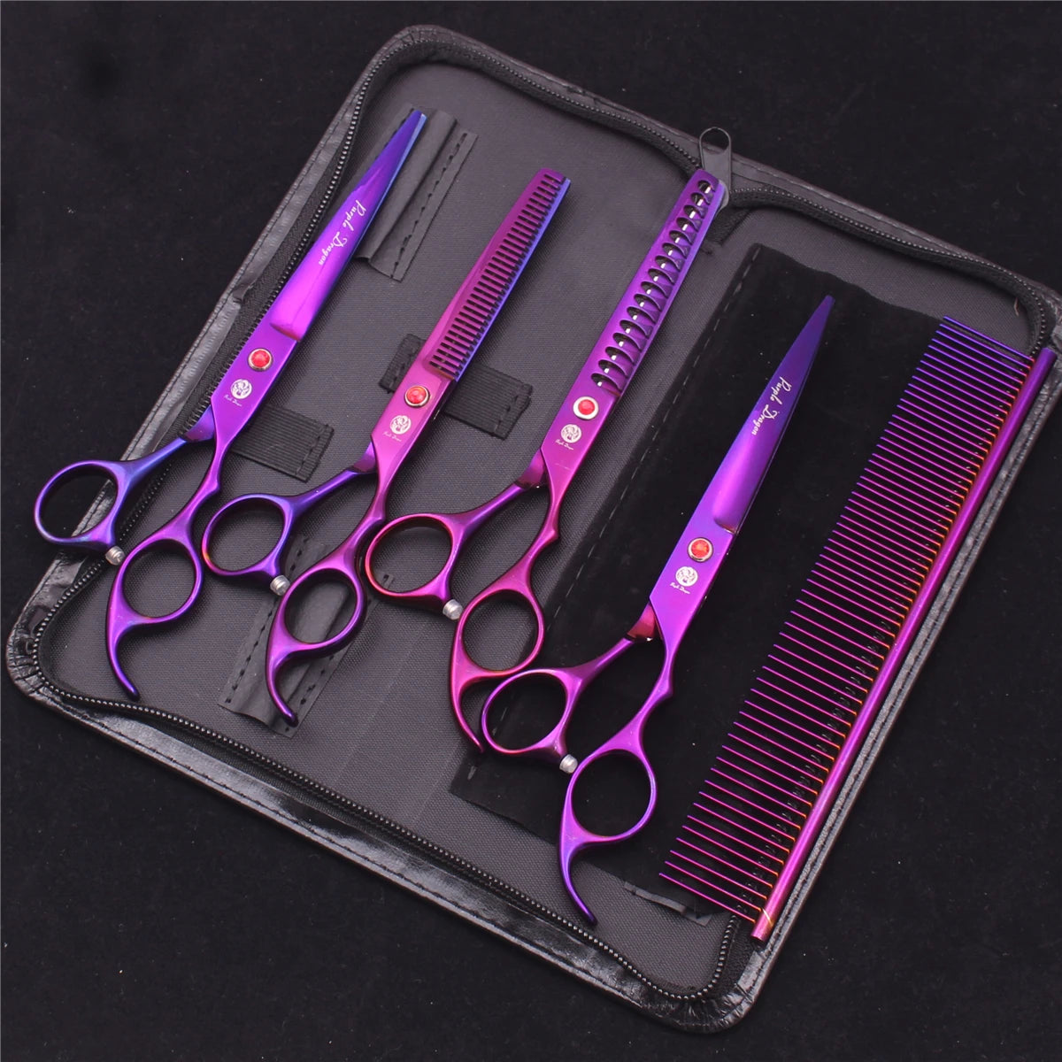 A set of professional stainless steel pet grooming scissors and a grooming comb in purple housed in a black case.
