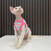 A white cat wearing a pink and blue striped stretchy tank top looking upwards.