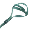A green bird training harness and leash set with a buckle visible.