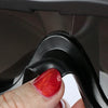 A hand is adjusting a black dog eye protection sunglass on a dark gray lens.