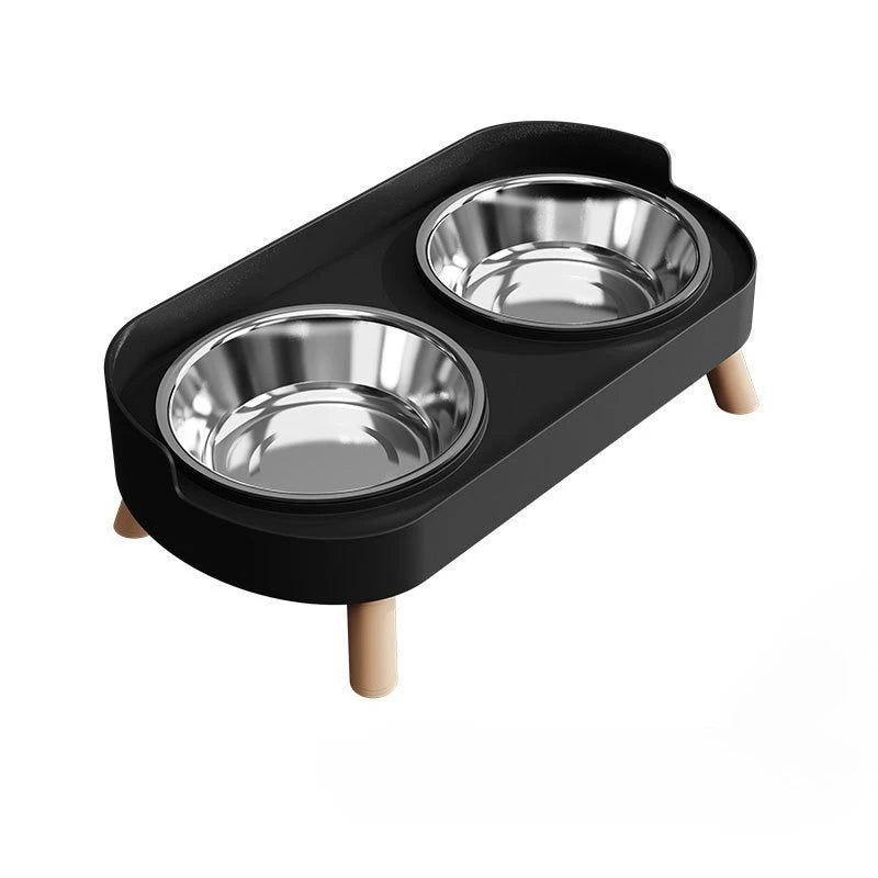 A black elevated cat food and water bowl set with two stainless steel bowls on a wooden stand.
