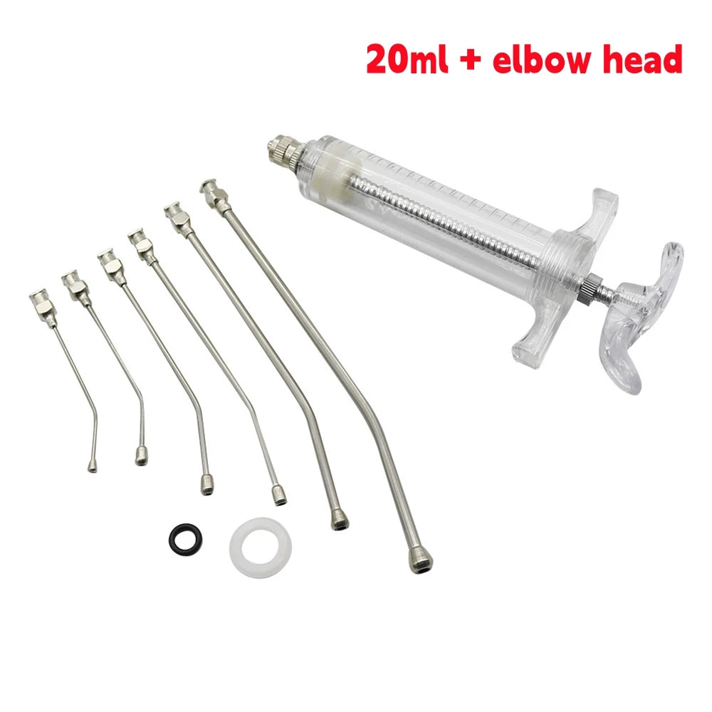 A clear plastic syringe with an elbow head and multiple stainless steel feeding needles for small animals