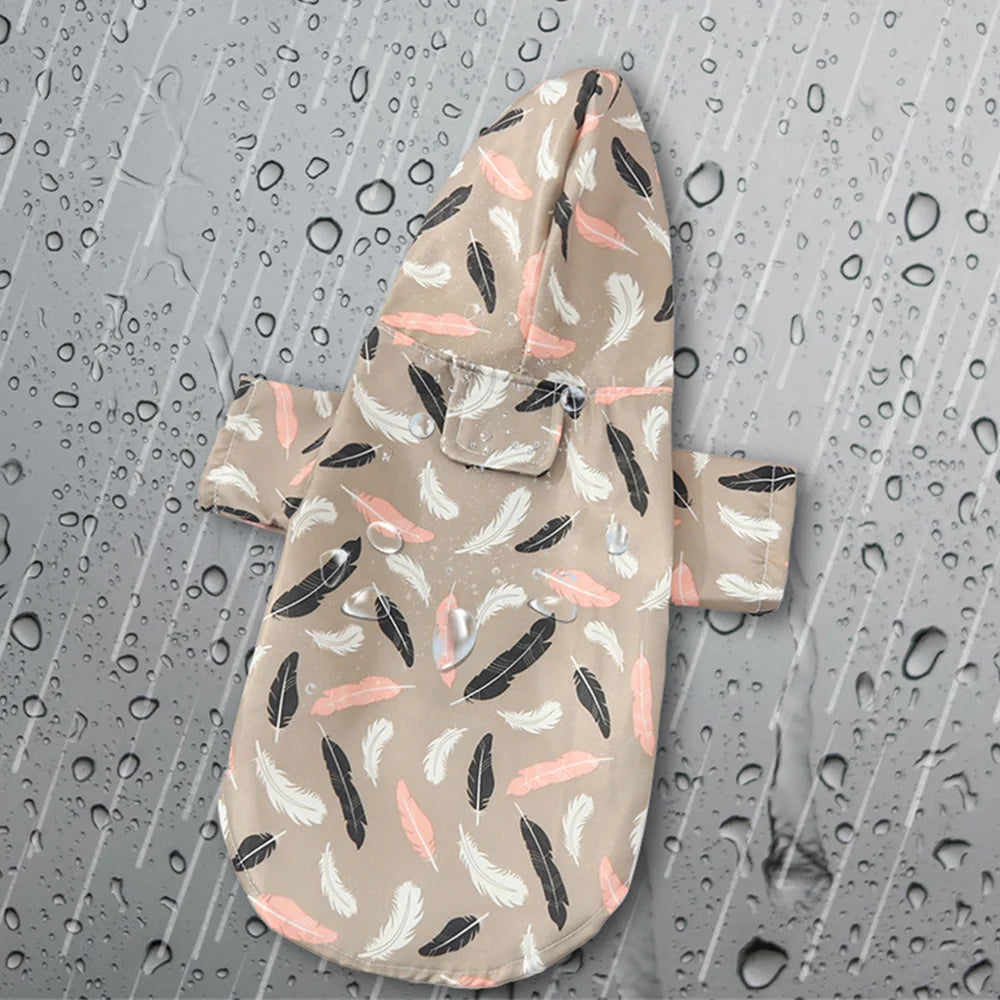 A beige cartoon printed dog raincoat with black and pink feather patterns is shown against a wet background.
